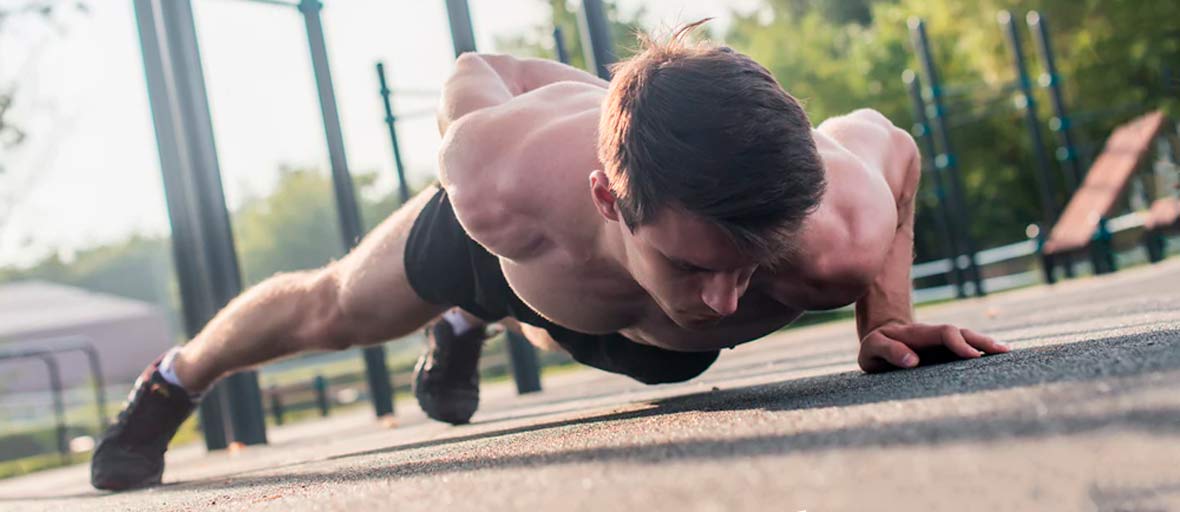 man doing push-ups on one arm